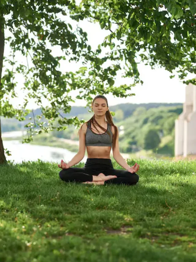 young-woman-relaxes-yoga-pose-nature-park_109529-1361